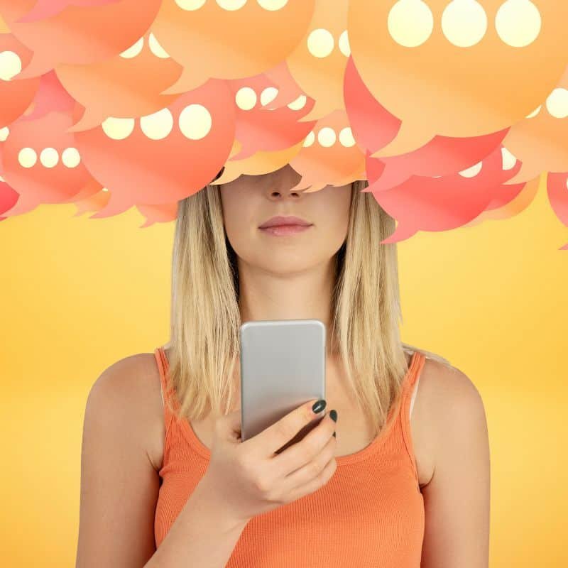 blond woman with smartphone in hand and hundreds of comment icons